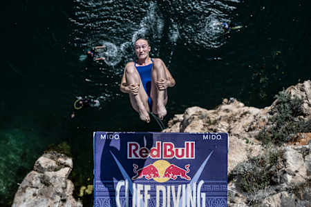 Elisa Cosetti of Italy dives from the 21 metre platform during the first stop of the 2024 Red Bull Cliff Diving World Series at Lake Vouliagmeni in Athens, Greece on May 25, 2024.