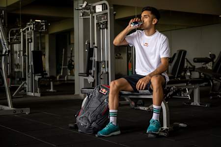 Lakshya Sen sips on a can of Red Bull during a fitness session in a gym