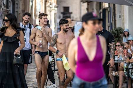 Andrea Barnaba nd Carlos Gimeno walk through the old town after diving during the second competition day of of the 2024 Red Bull Cliff Diving World Series in Polignano a Mare, Italy