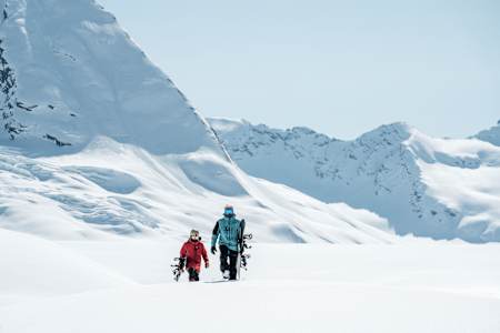 Kai Lenny and Travis Rice snowboarding together in Valdez, Alaska