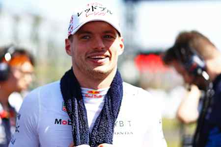 Max Verstappen with towel draped around neck as he looks onto the grid prior to the F1 Japan Grand Prix.