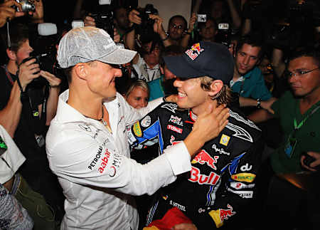 Sebastian Vettel (d.) reçoit les félicitations de son héros, Michael Schumacher (g.) après avoir remporté le titre de Champion du Monde 2010, à Abu Dhabi.