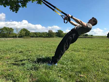 How to perform reverse fly using a TRX