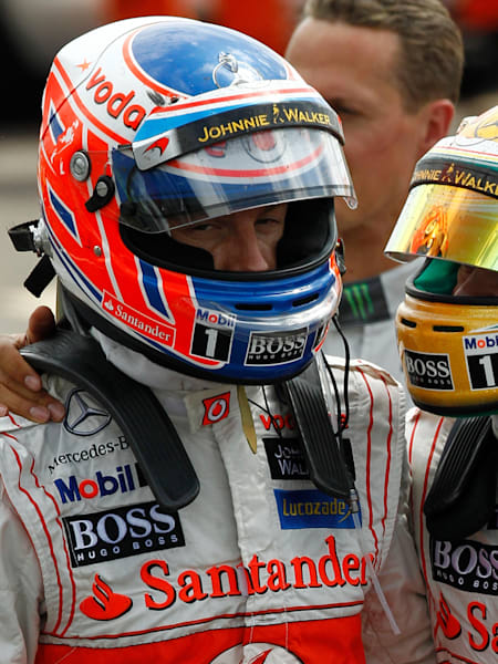 Jenson Button with his arm around McLaren team-mate Lewis Hamilton at Silverstone.