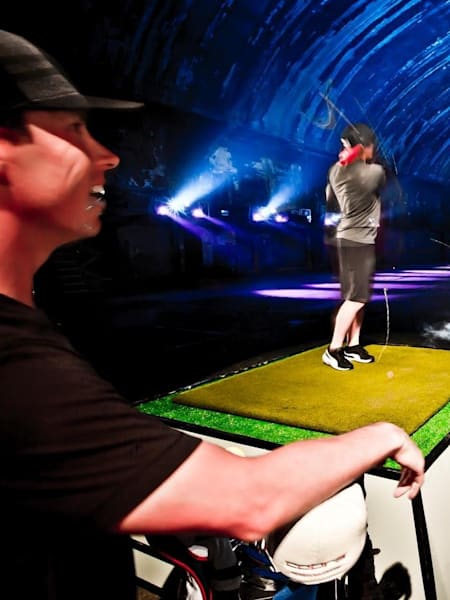 Rickie Fowler hitting a ball in the psychedelic driving range.