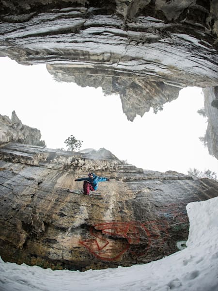 Nico Vuignier jibbing rock in a natural canyon
