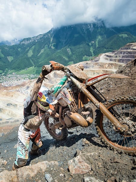 Dougie Lampkin pushing his bike uphill