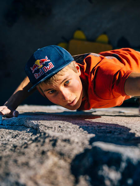 Alex Megos reaches for a good hold on a rock face