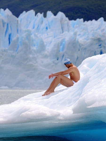 A swimmer sits on ice at the Perito Moreno Glacier, Argentina. 