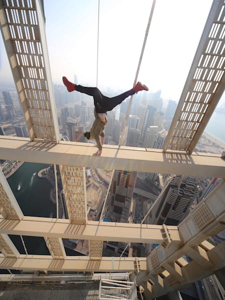 A man does a handstand over Dubai