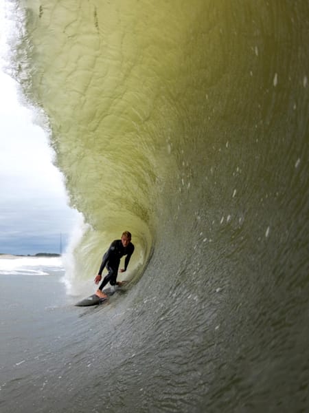 Surfer Tommy Ihnken in a barrel in Cape May New Jersey East Coast USA