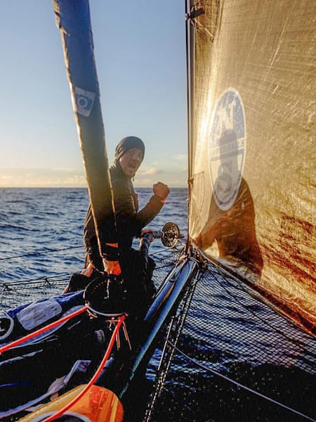 Travis Rice sits on the bow of Falcon as they sail to Antigua from Bermuda.