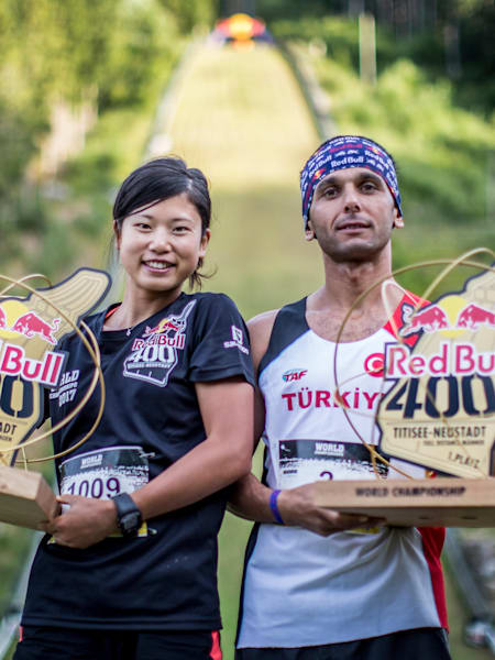 Yukari Tanaka of Japan and Ahmet Arslan of Turkey celebrate with their winners trophies after the Red Bull 400 World Championship at Titisee-Neustadt, Germany on July 15th 2017.