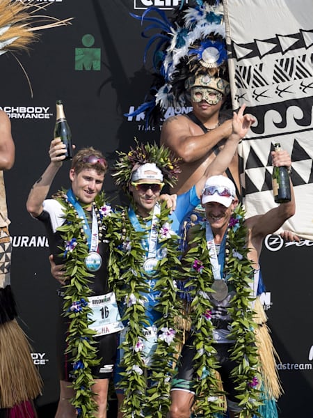 Patrick Lange, Lionel Sanders and David McNamee celebrate their win.