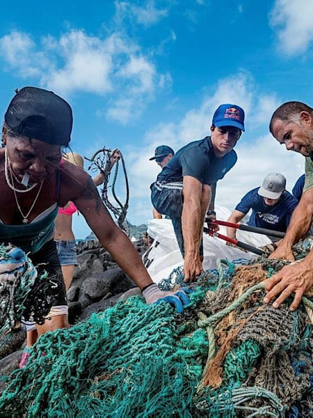 In March 2017, Kai Lenny (center) led the largest coastal cleanup in Hawaii history, collecting more than 11,000 pounds of debris.
