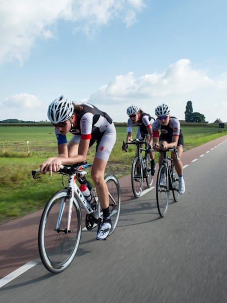 Cyclists ride in a line