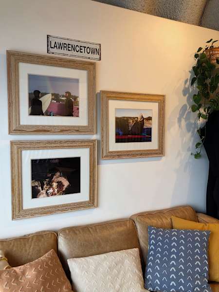 Three photos captured by local surf photographers displayed at Lawrencetown Surf Co.. 