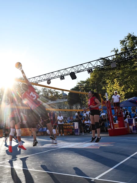A player makes a smash shot during a volleyball match.
