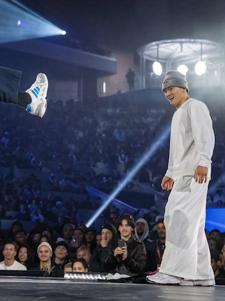 Hong 10 of Korea (L) competes against Phil Wizard of Canada