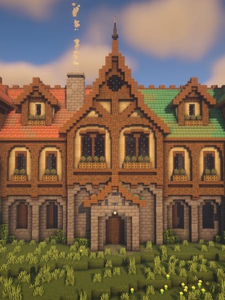 Un imposant manoir construit dans Minecraft, avec deux tours à horloge, des toits colorés, des façades en bois et en pierre et de nombreuses fenêtres.