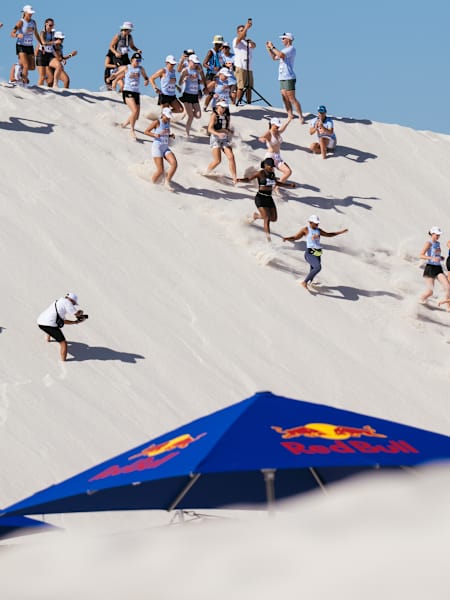 Participants sprint down the steep white sands during Red Bull Dune Dusters 2026 at Atlantis Dunes, Cape Town, capturing the thrill and adventurous spirit of this iconic Red Bull event