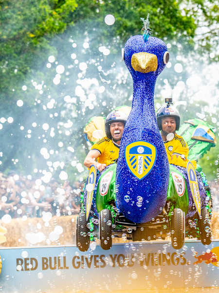 On 20th June 2026, Leeds United Football Club thrill crowds at Red Bull Soap Box in Alexandra Palace, London, racing their vibrant peacock-themed cart through bubbles and cheers