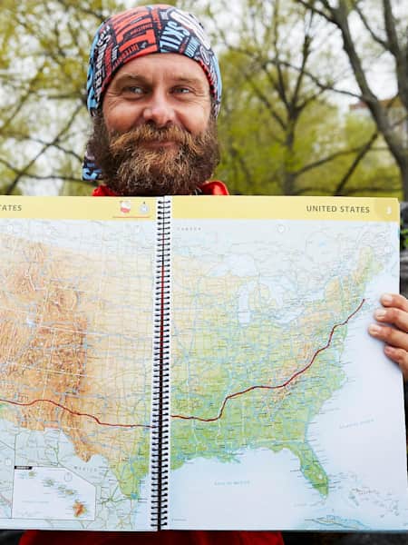 Ultra-runner Patrick Sweeney with the map of his trans-America running route from Los Angeles to Boston, which he completed in 114 days