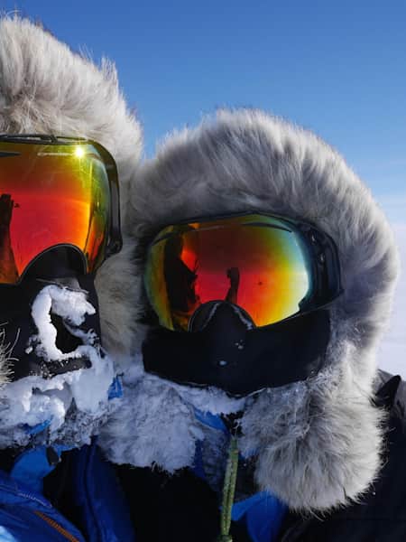 Ben Saunders and Tarka portrait wearing their visors at South Pole