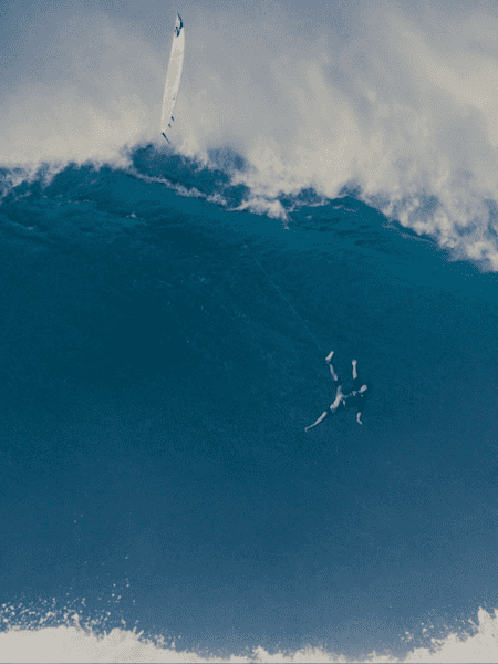 Surfer Tom Dosland flies through the air on a huge wave at Jaws