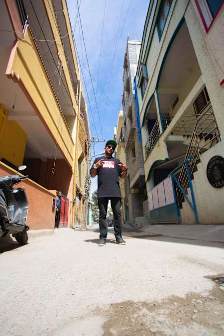 Rapper Gubbi poses for a photo in front of his house at SG Palya in Bengaluru