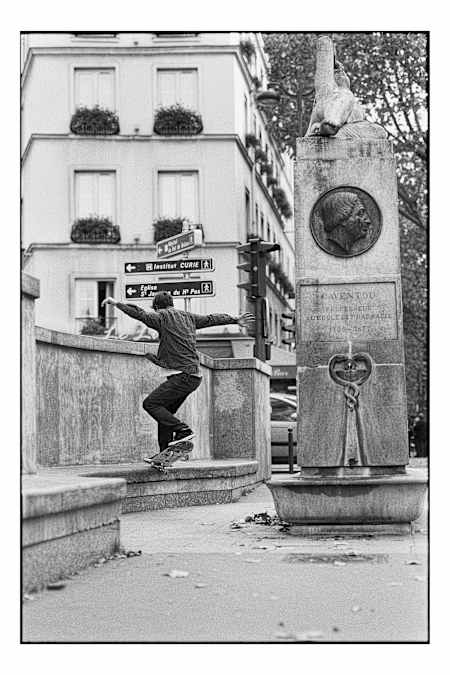 Boris Proust styles out on the long fountain-side bench ledge on Paris' Boulevard Saint Michel