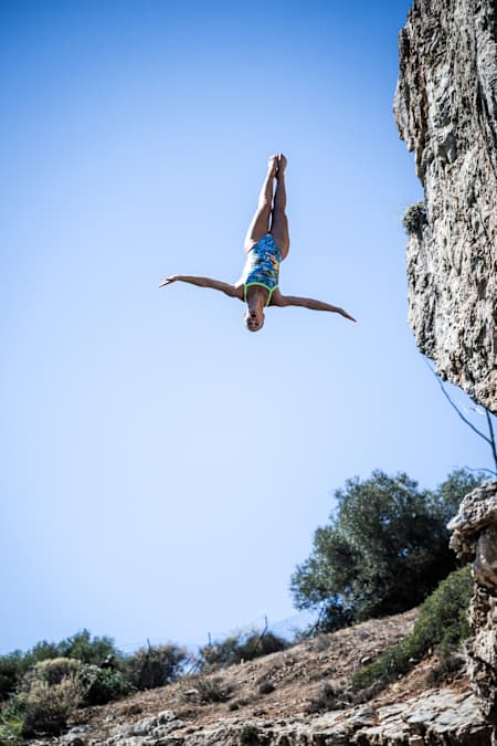 Eleanor Smart of the USA dives from the 20 metre cliff during the first competition day of the 2024 Red Bull Cliff Diving World Series at Lake Vouliagmeni in Athens, Greece on May 24, 2024.