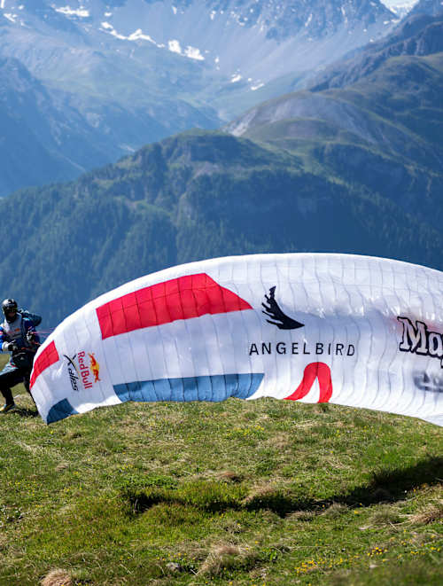 Adventure unfolds as Benedikt Dornauer of team AUT3 takes flight during Red Bull X-Alps in Guarda, Switzerland in 2025, soaring over breathtaking alpine terrain