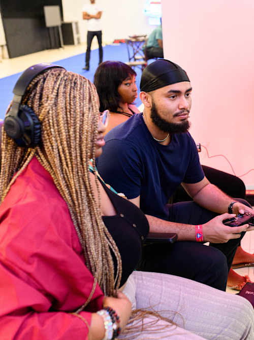 Players immersed in intense eSports competition during Red Bull Login Nigeria 2023 at The Eco bank headquarters in Lagos, captured with gaming gear and a signature Red Bull can