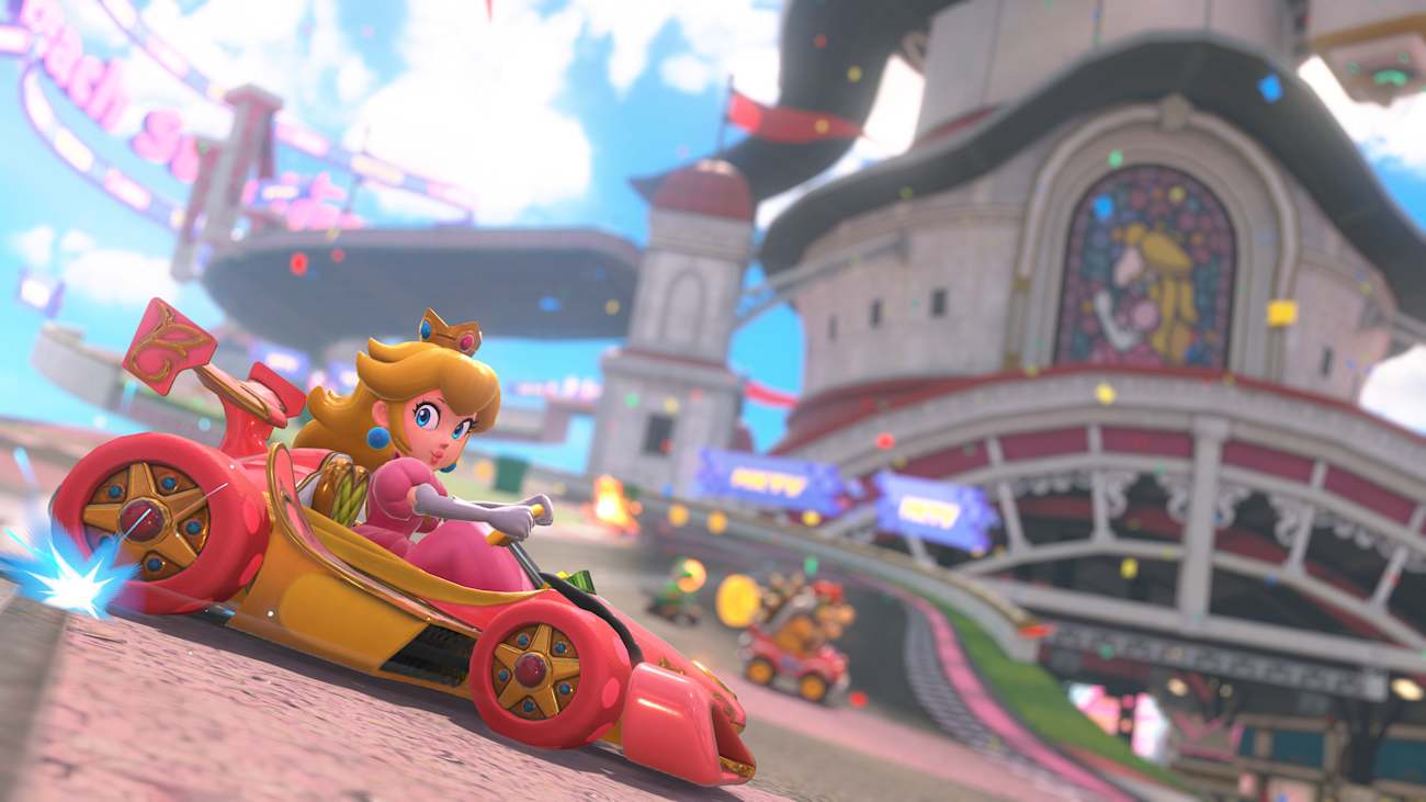 Screenshot aus Mario Kart World zeigt Prinzessin Peach in einem Formel-Rennwagen vor ihrem Schloss.