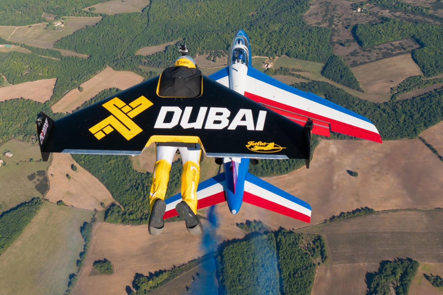 Watch three guys with jetpacks fly in formation with airplanes