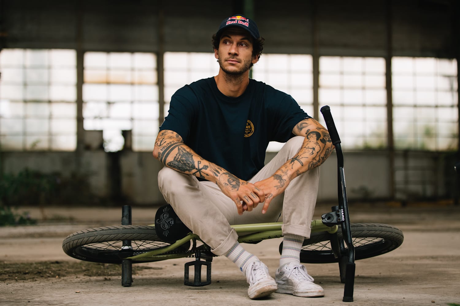 Matthias Dandois Sitting Outside on his Green Bike