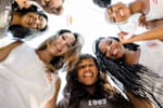 Red Bul student brand managers stand in a circle and look into the camera from above