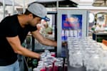 Student ambassador sorts Red Bull cans in a refrigerator at a event on campus