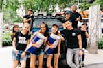International Red Bull wings team posing together in front of a Red Bull truck