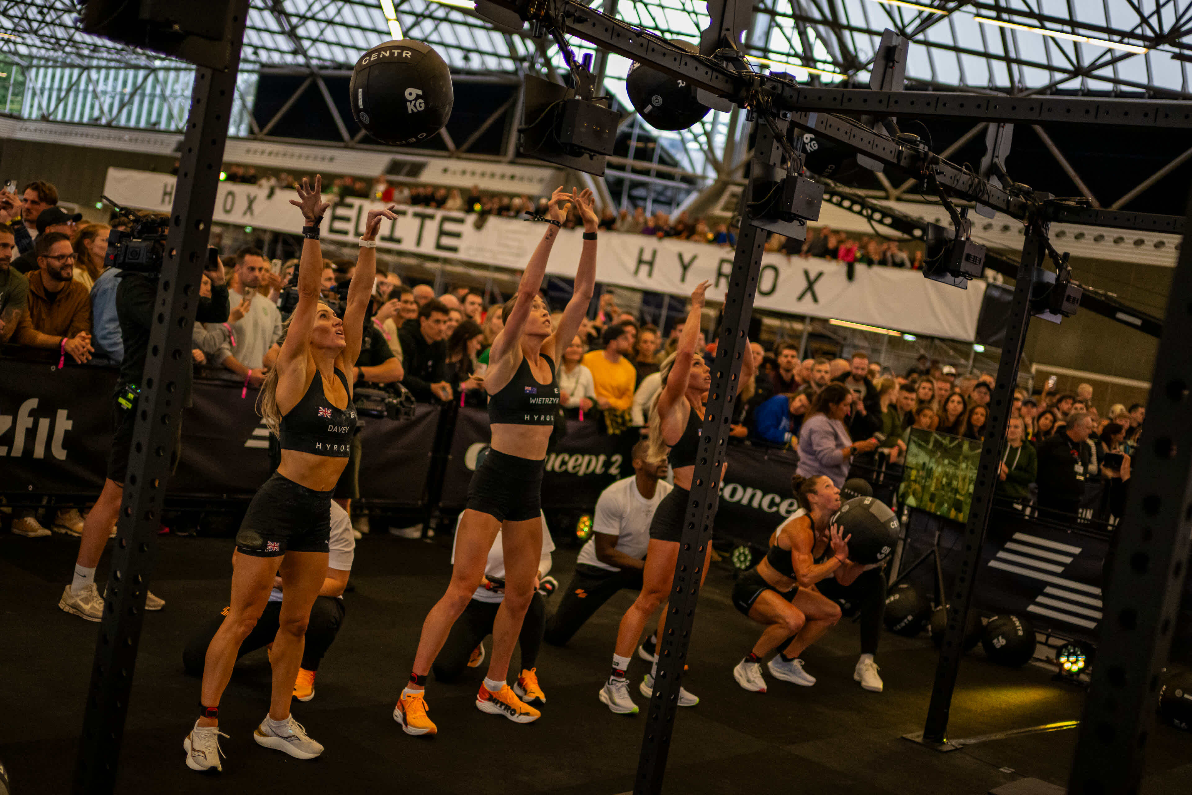 HYROX athletes performing wall balls at the final station