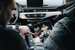 Red Bull sales striker is shown Red Bull power selling and power coaching by an experienced manager on a tablet while sitting in the car -163105-039248.jpg