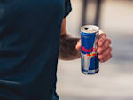 A man holding a Red Bull can who starts his career at Red Bull and in doing so works for a company that develops unique marketing concepts