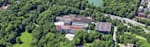 Red Bull Munich headquarter from a distant view surrounded by green landscape