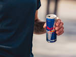 A man holding a Red Bull can who starts his career at Red Bull and in doing so works for a company that develops unique marketing concepts
