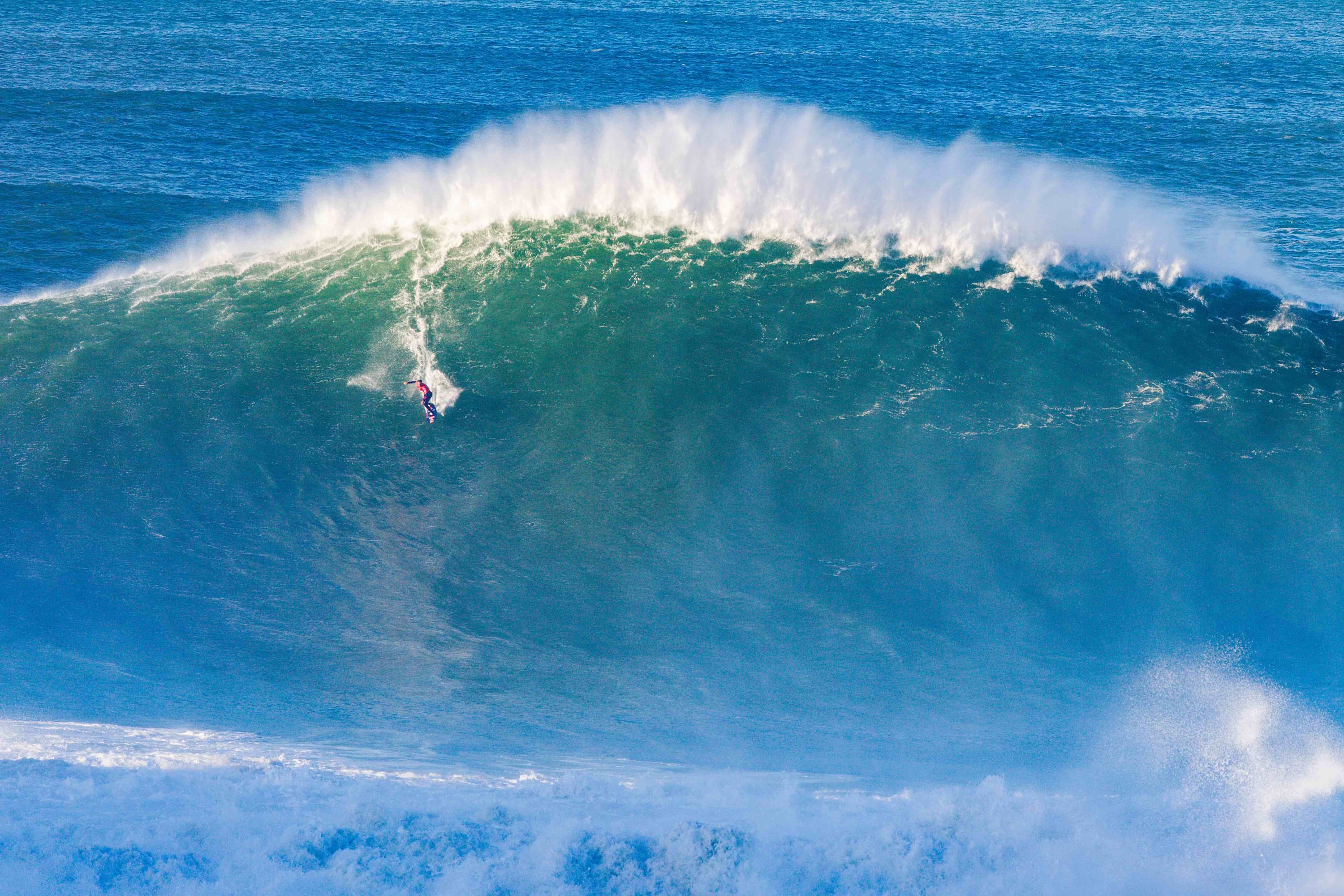 Kai Lenny takes the drop while surfing in Portugal